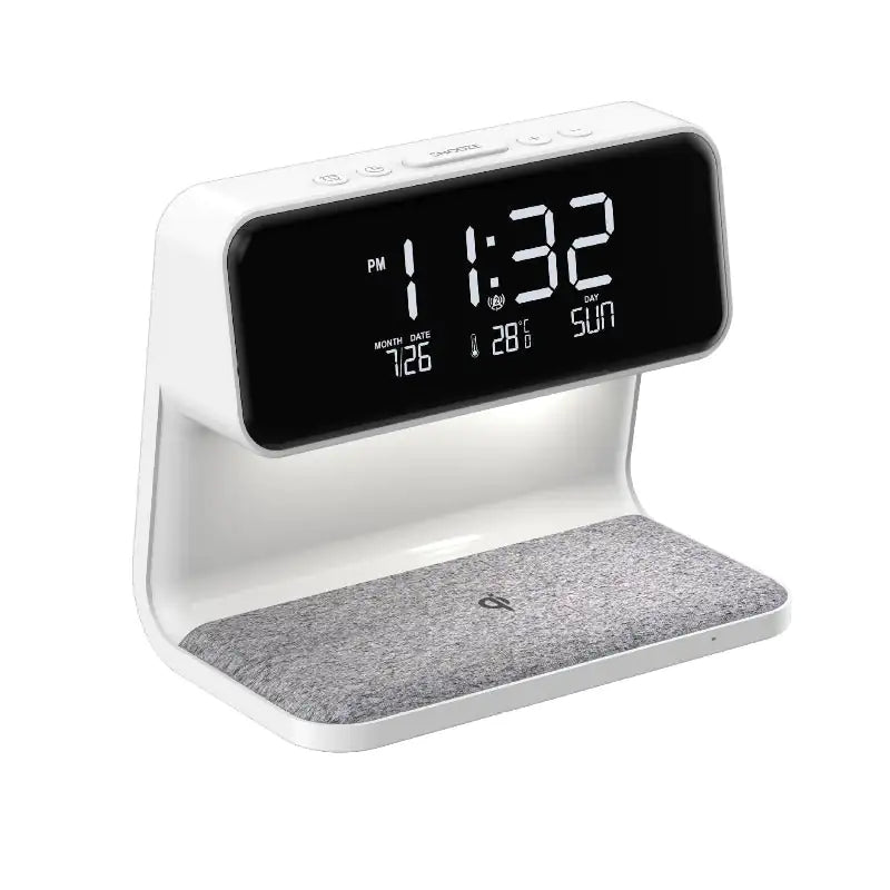 Despertador con pantalla LCD 3 en 1 junto a la cama